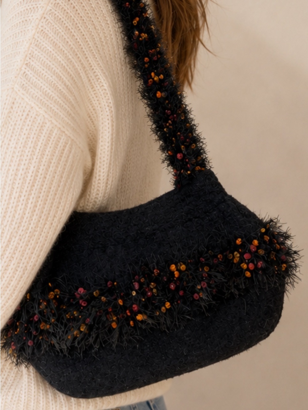 Unique Statement purse woven with black,orange,red feathery details.